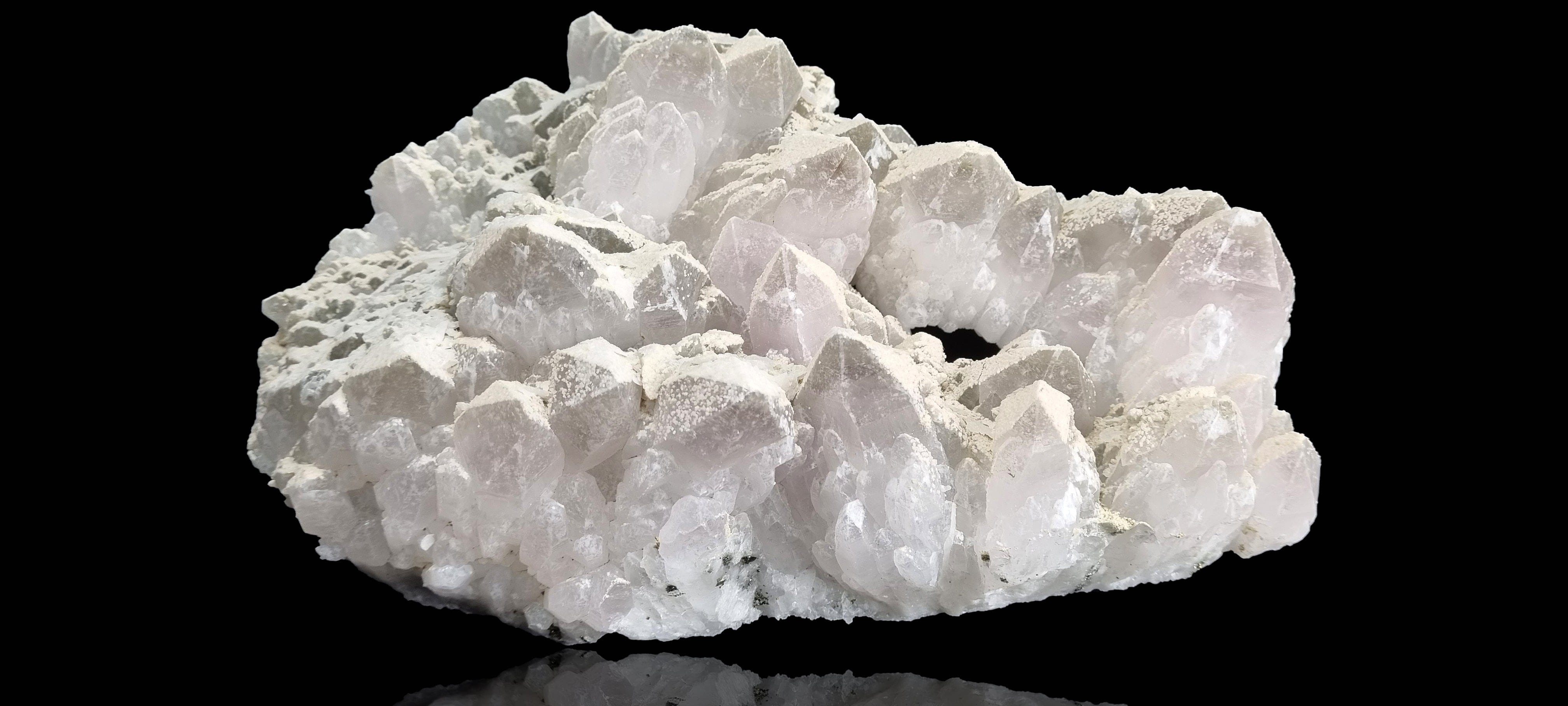 Quartz crystal cluster with a preferential dusting of Calcite and minor Pyrite on matrix