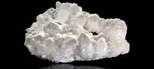 Quartz crystal cluster with a preferential dusting of Calcite and minor Pyrite on matrix