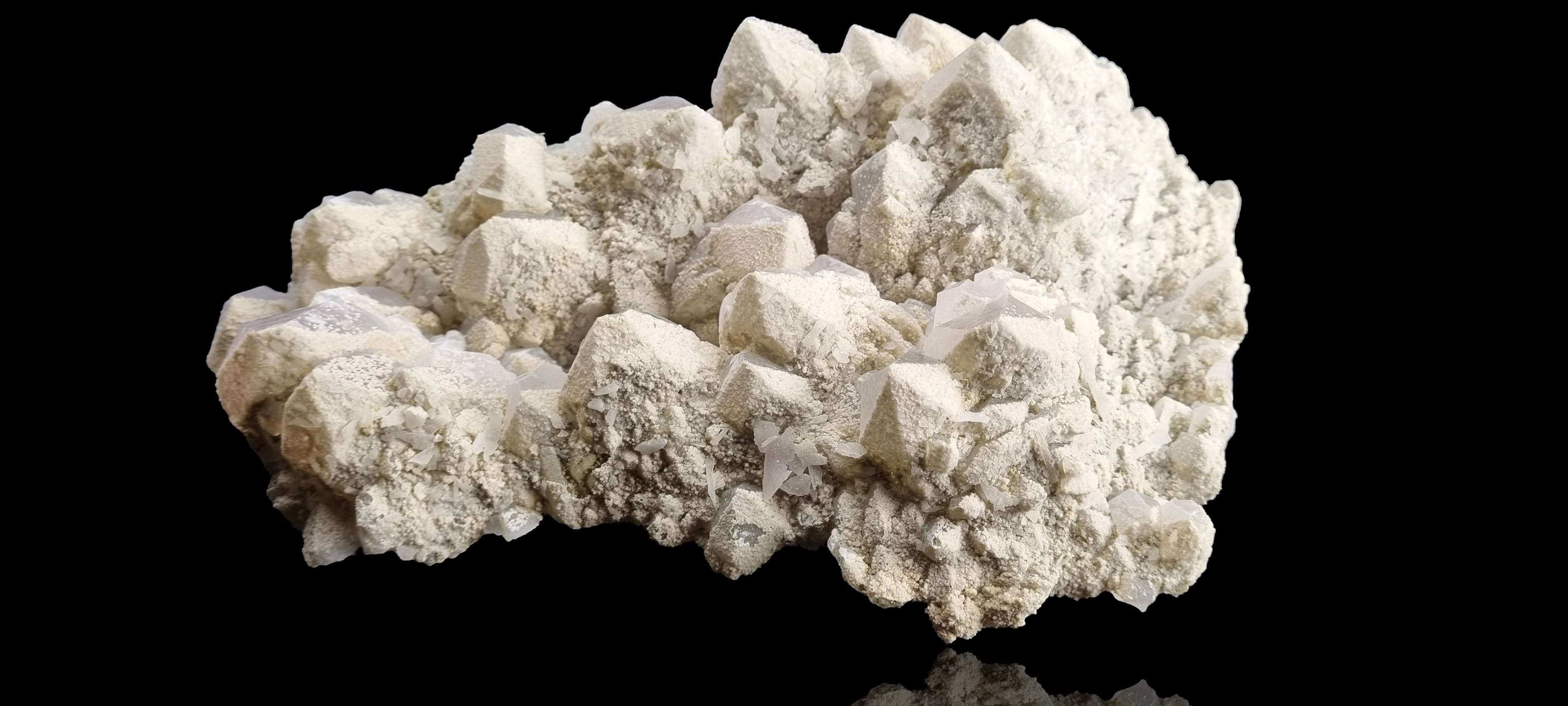 Quartz crystal cluster with a preferential dusting of Calcite and minor Pyrite on matrix