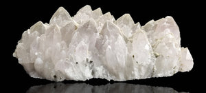 Quartz crystal cluster with a preferential dusting of Calcite and minor Pyrite on matrix