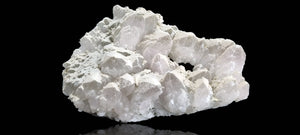 Quartz crystal cluster with a preferential dusting of Calcite and minor Pyrite on matrix